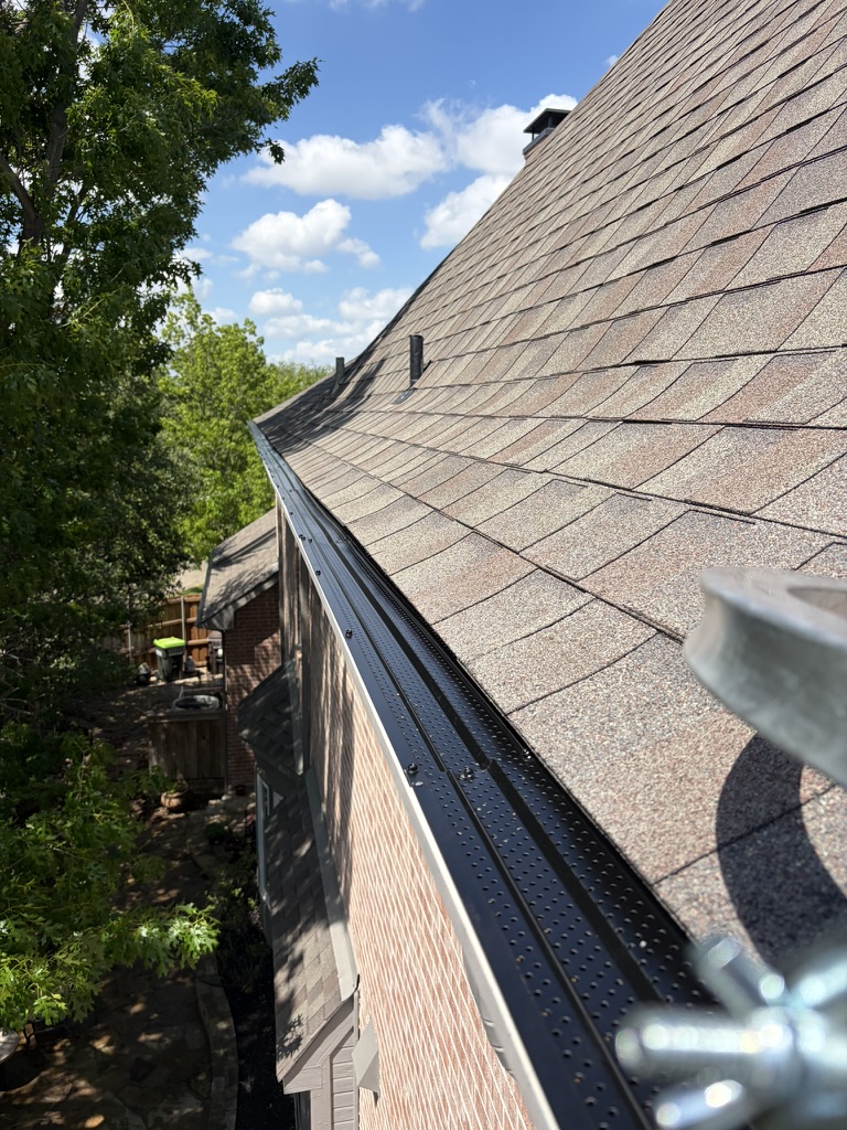 Residential roof and gutters after a low-pressure soft wash in the Carrollton area